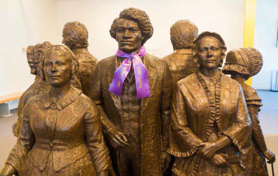 Frederick Douglass is portrayed with fellow suffragists at the Women’s
Rights National Historical Park in Seneca Falls, New York. Douglass
participated in the first women’s rights convention on this site and also
spoke at the first “national” Woman’s Rights Convention in Worcester
in 1850. Alamy