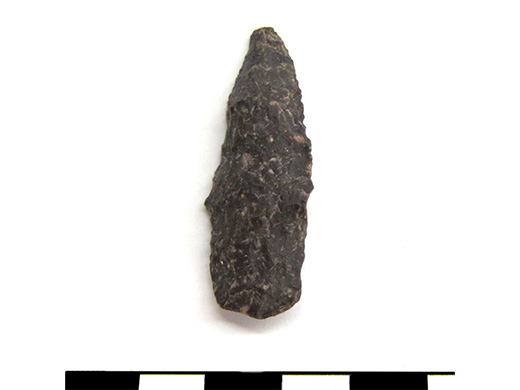  Chipped stone tool. Small stemmed point, purple felsite. Spectacle Island, MA.