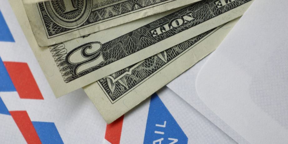 Protect Yourself from the “Grandparent Scam” photo illustration of money on envelopes.