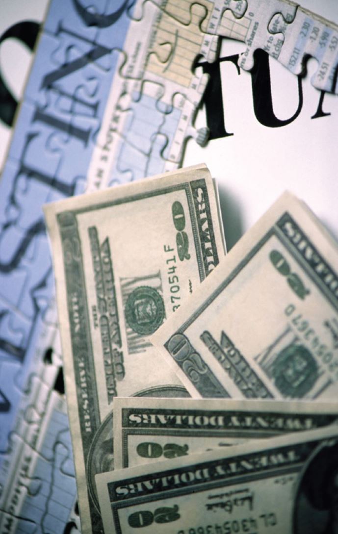 Photo illsutration of money on a puzzle